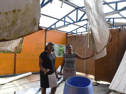 Tanshea Williams-Johnson (left), Vice Principal, St Mary Technical High school, Marvalee Tomlinson-Russell (right), head of the 6th Form Department, inspects the 6th form block that was damaged during the passage of Hurricane Melissa on October 28, 2025.