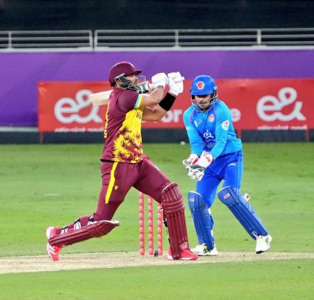West Indies captain Brandon King pulls to leg during an innings of 50 against Afghanistan in the second T20 International in Dhubai yesterday. Looking on is Afghan wicketkeeper Rahmanullah Gurbaz.